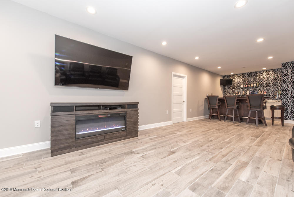 11 Round Hill Road Jackson, NJ 08527 - Photo 57 of 69 a living room with furniture and a flat screen tv