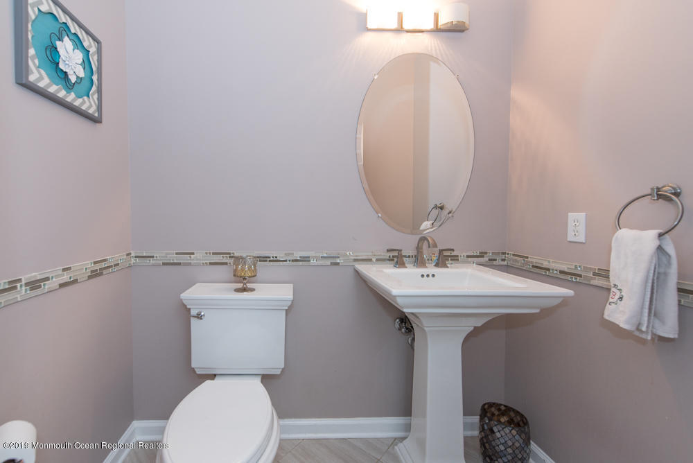 11 Round Hill Road Jackson, NJ 08527 - Photo 63 of 69 a bathroom with a toilet a sink and mirror