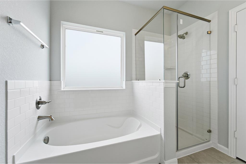 343 Caviar Road Waxahachie, TX 75165 - Photo 14 of 22 a white bath tub sitting next to a shower