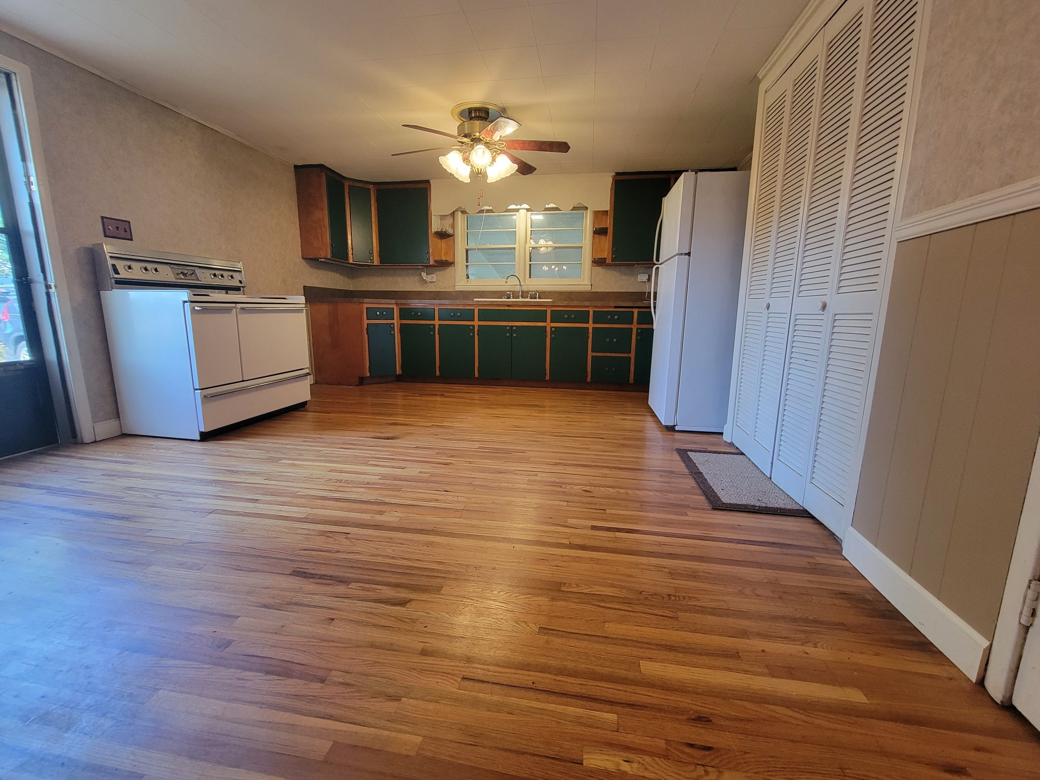 2992 Gum Creek Road Decherd, TN 37324 - Photo 11 of 25 a view of a kitchen with a sink cabinets and wooden floor