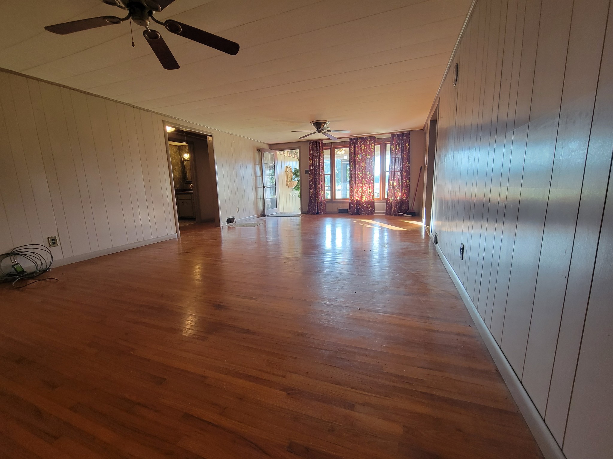 2992 Gum Creek Road Decherd, TN 37324 - Photo 8 of 25 an empty room with wooden floor fan and windows