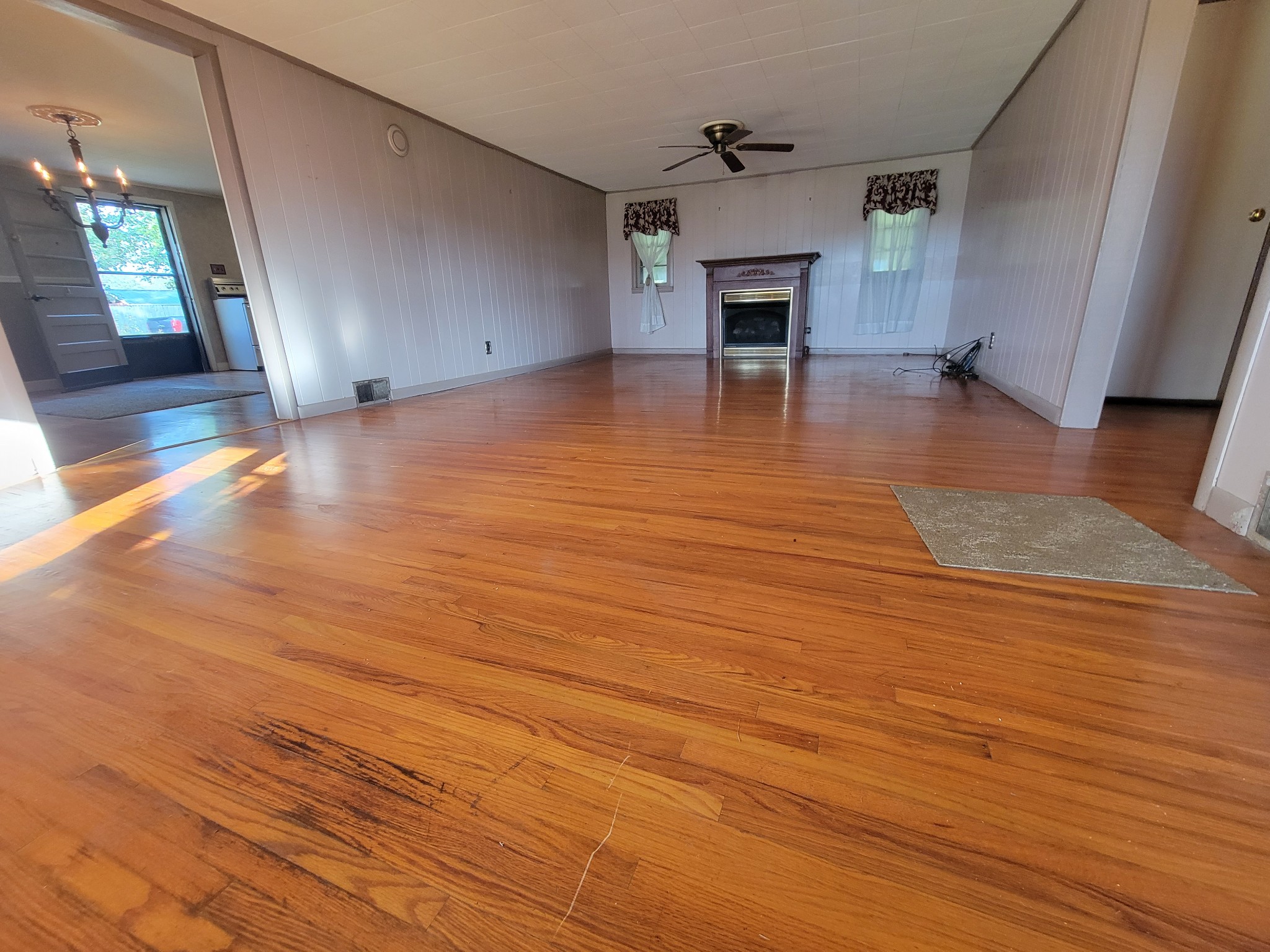 2992 Gum Creek Road Decherd, TN 37324 - Photo 9 of 25 an empty room with wooden floor and fireplace