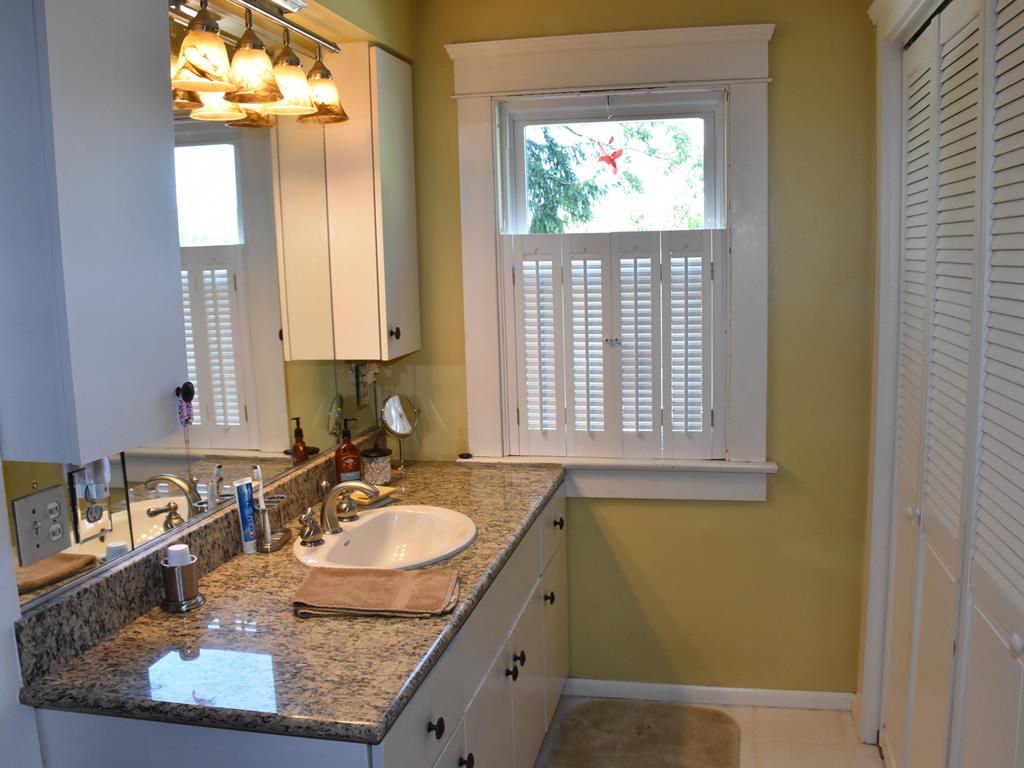 655 Chestnut Street Meadville, PA 16335 - Photo 31 of 43 a bathroom with a granite countertop sink and a mirror