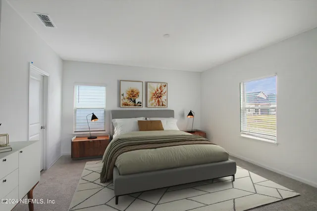 a bedroom with a bed and a potted plant