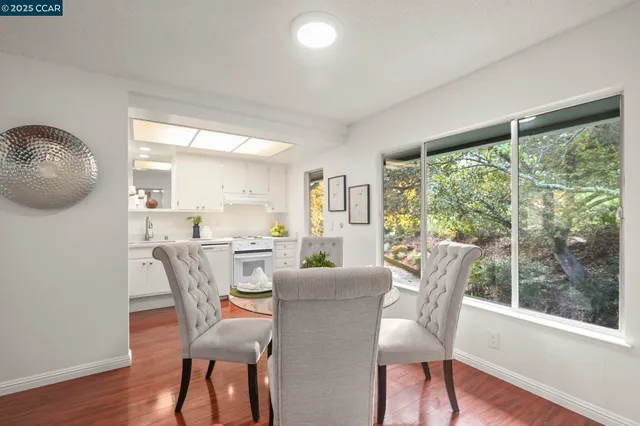 a view of a dining room with furniture window and wooden floor