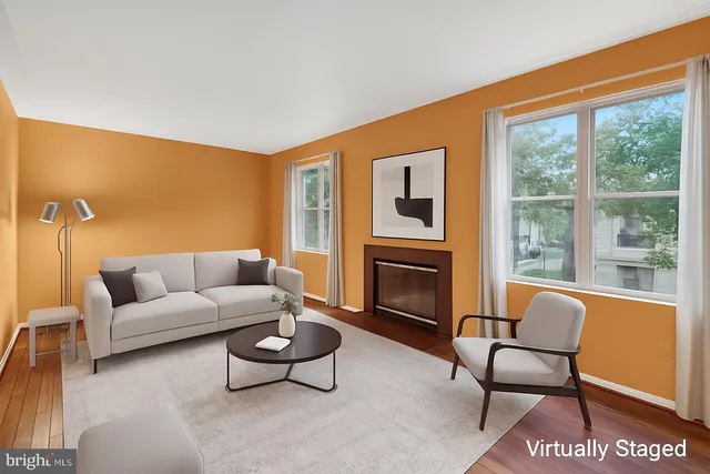 a view of empty room with wooden floor and fireplace