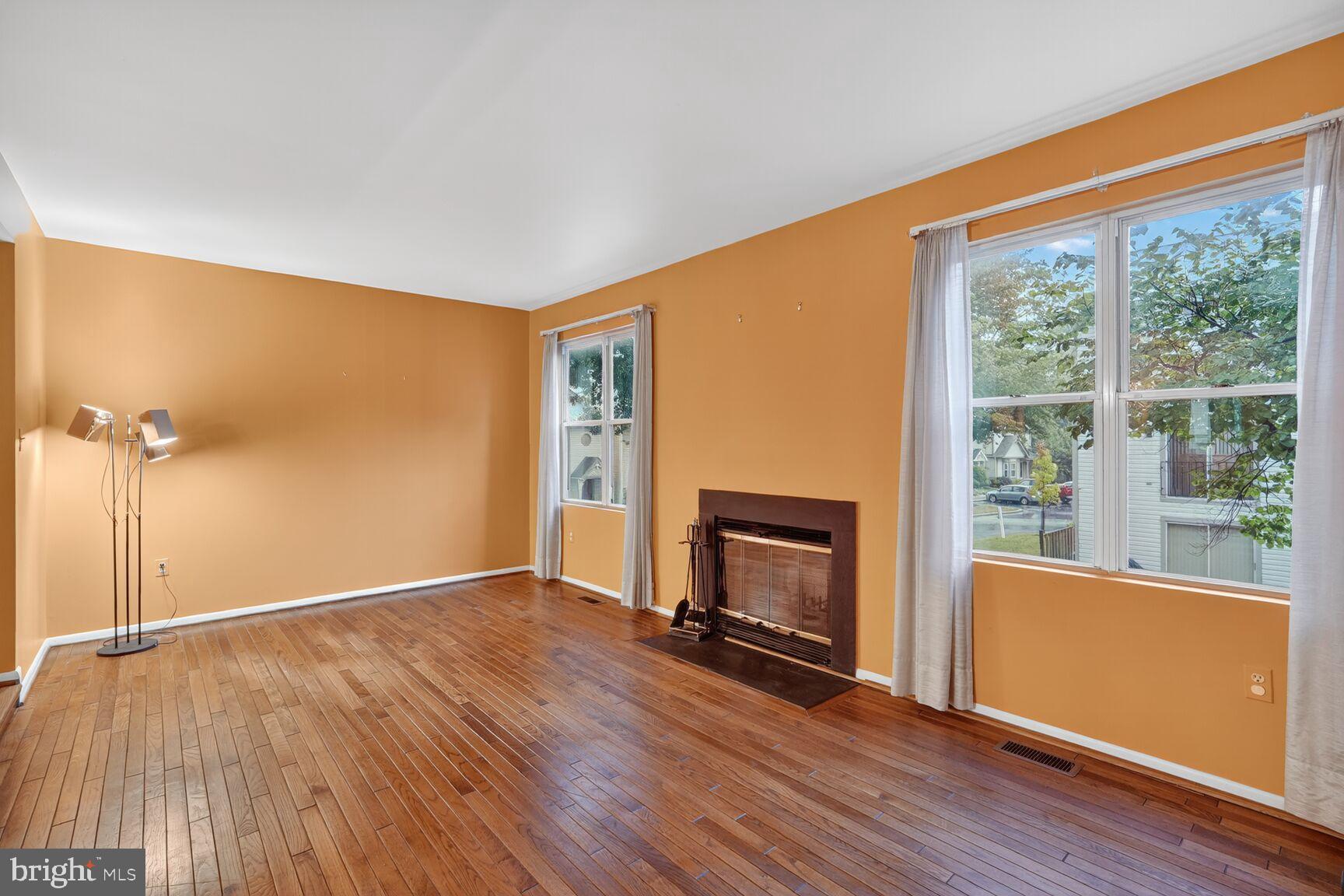 2890 Schoolhouse Circle Silver Spring, MD 20902 - Photo 10 of 23 a view of empty room with wooden floor and fireplace