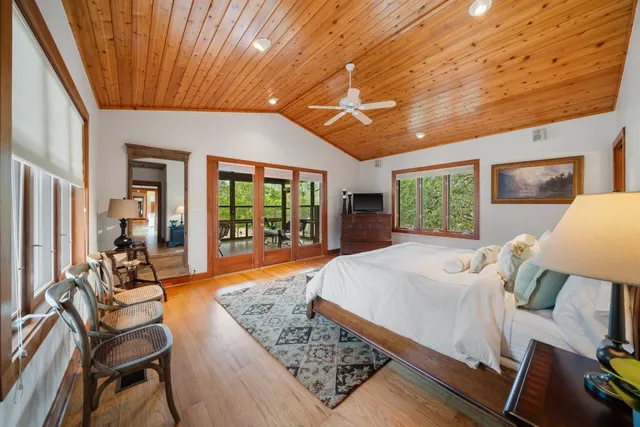 a bed room with a bed and a chair