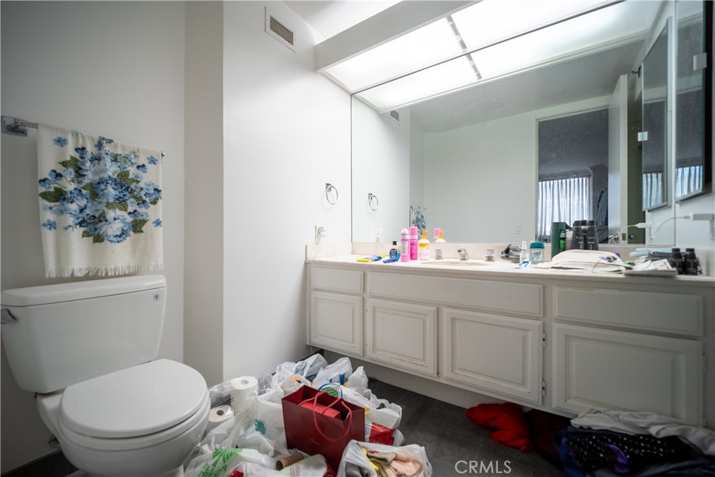 222 Monterey Road, Unit 206 Glendale, CA 91206 - Photo 13 of 22 a bathroom with a toilet sink and mirror