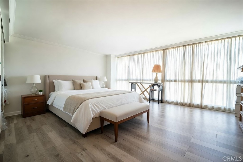 222 Monterey Road, Unit 206 Glendale, CA 91206 - Photo 4 of 22 a bedroom with a large bed and a large window with outer view