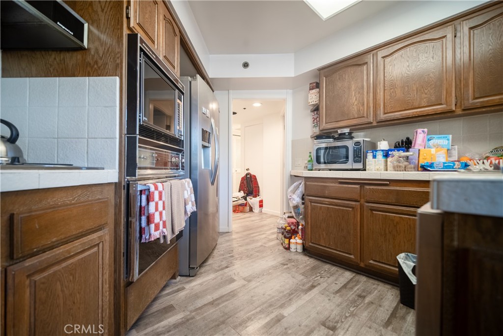 222 Monterey Road, Unit 206 Glendale, CA 91206 - Photo 7 of 22 a kitchen with stainless steel appliances granite countertop a refrigerator and microwave