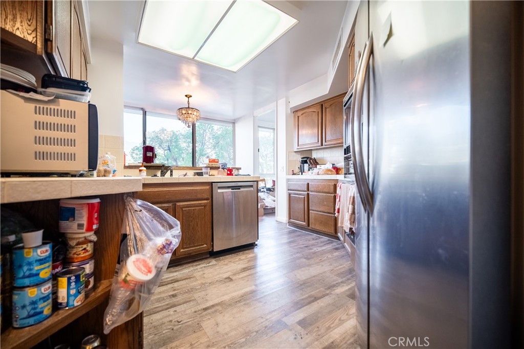 222 Monterey Road, Unit 206 Glendale, CA 91206 - Photo 8 of 22 a kitchen with stainless steel appliances a sink a stove a refrigerator cabinets and a window