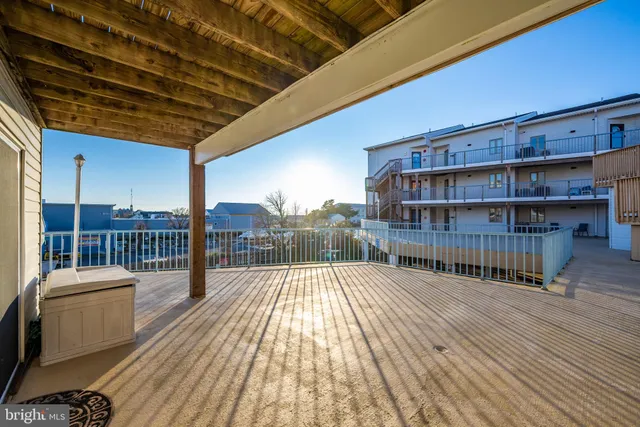 a view of a balcony with wooden floor and pool table