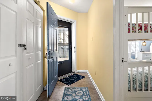 a view of a hallway with wooden floor and a dining room