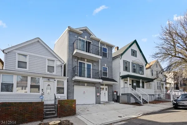 a front view of a residential apartment building with a yard