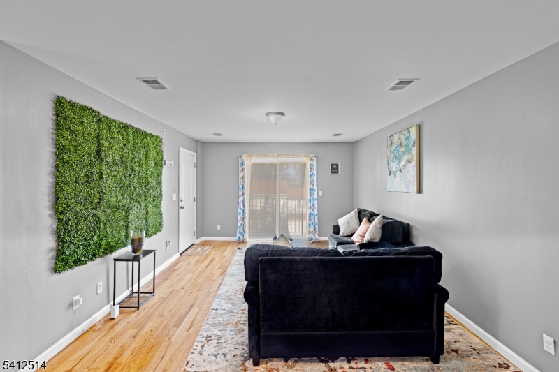 73 Winans Avenue, Unit 2 Newark, NJ 07108 - Photo 4 of 13 a living room with furniture and a window