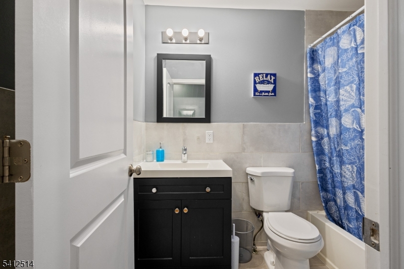 73 Winans Avenue, Unit 2 Newark, NJ 07108 - Photo 5 of 13 a bathroom with a toilet sink and mirror