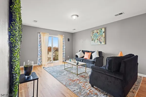 a living room with furniture and a potted plant