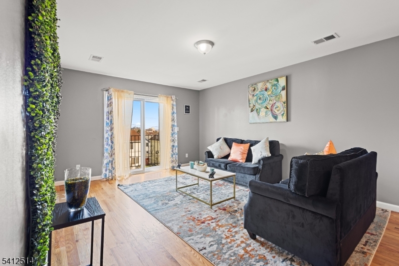 73 Winans Avenue, Unit 2 Newark, NJ 07108 - Photo 6 of 13 a living room with furniture and a potted plant