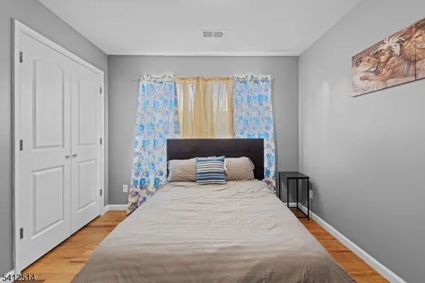 a bedroom with a large bed and a window