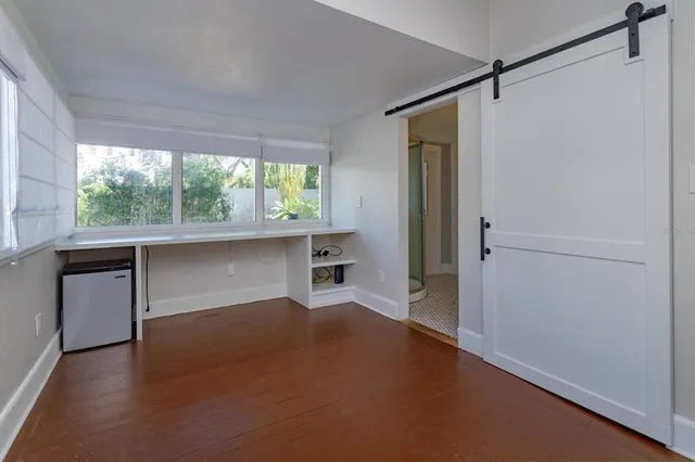 a room with window and hardwood floor