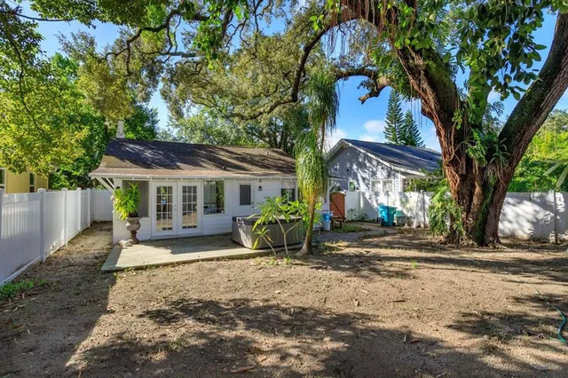 a view of a house with a tree in the yard