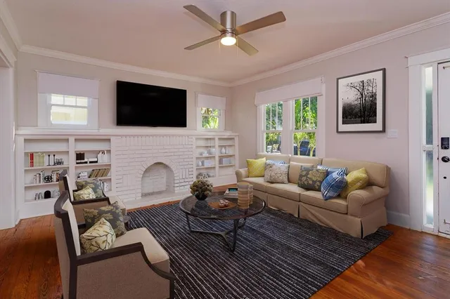 a living room with furniture fireplace and a flat screen tv