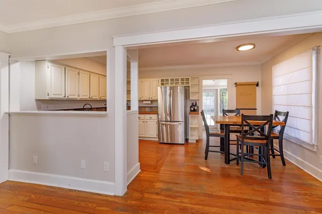 a view of a dining room with furniture and wooden floor