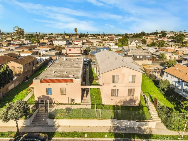 an aerial view of residential houses with city view