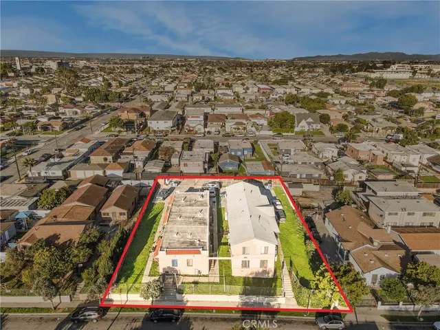 an aerial view of residential houses with outdoor space