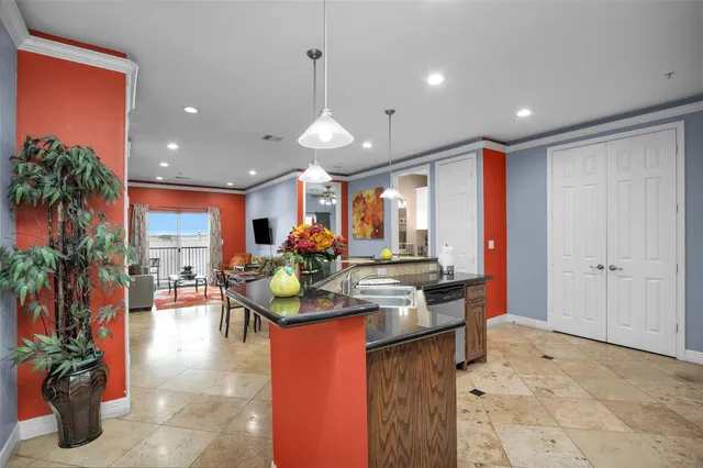 a view of a dining room and livingroom with furniture wooden floor a chandelier