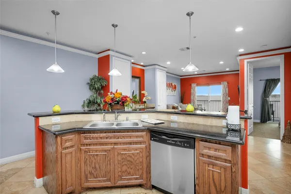 a kitchen with stainless steel appliances granite countertop a sink a stove and a wooden floors