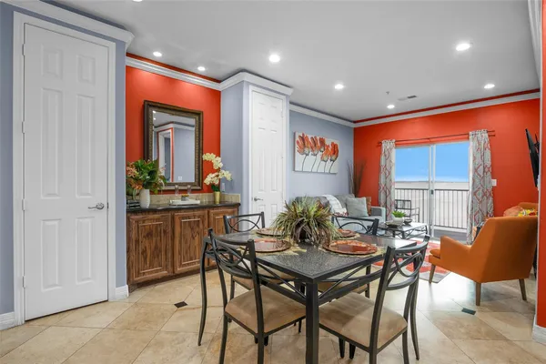 a dining room with furniture a window and a kitchen