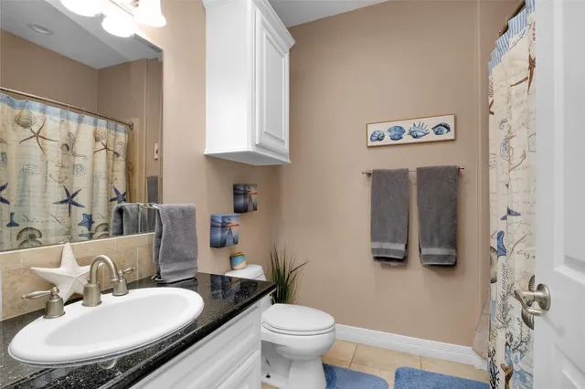 a bathroom with a toilet sink and a mirror