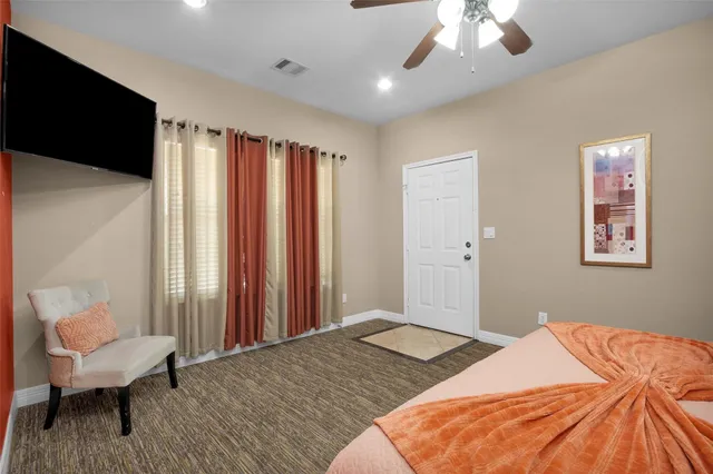 a bedroom with a bed and a chair