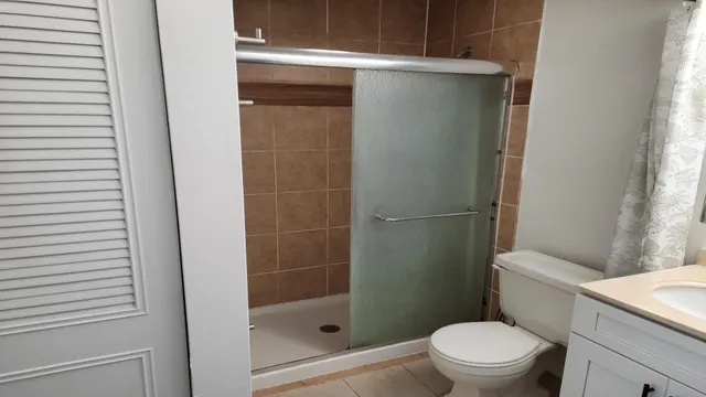a white toilet sitting next to a bathroom sink