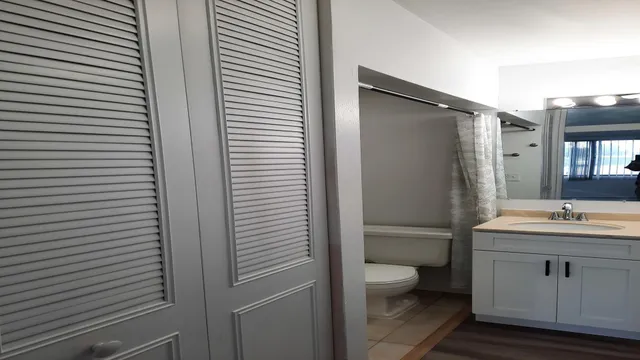 a bathroom with a toilet a sink and shower