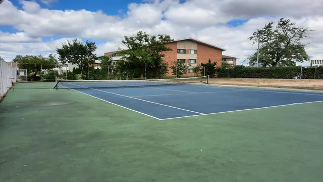 a view of a playground with basketball court