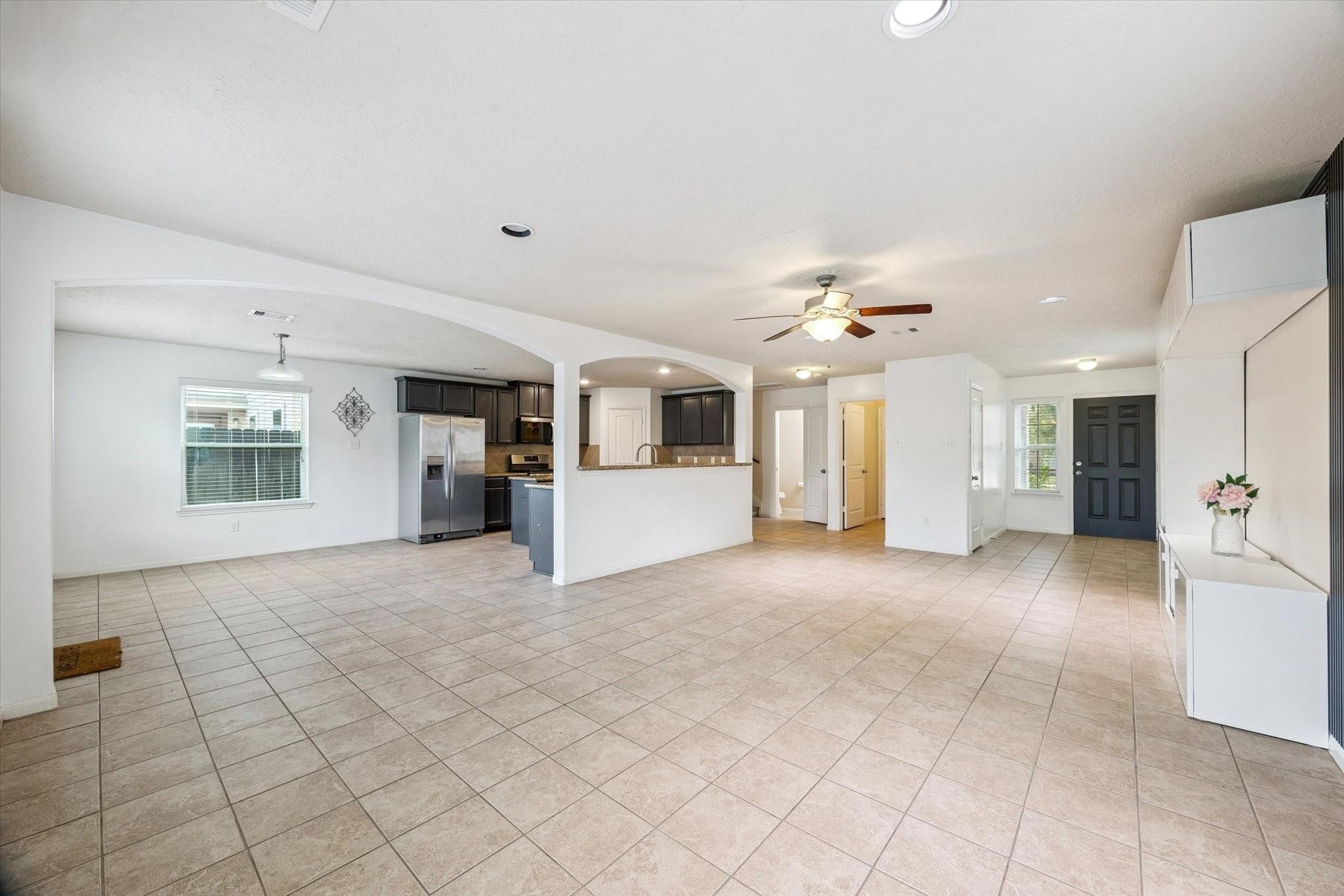 11718 Red Hummingbird Drive Houston, TX 77047 - Photo 2 of 13 a view of a livingroom with furniture and kitchen view