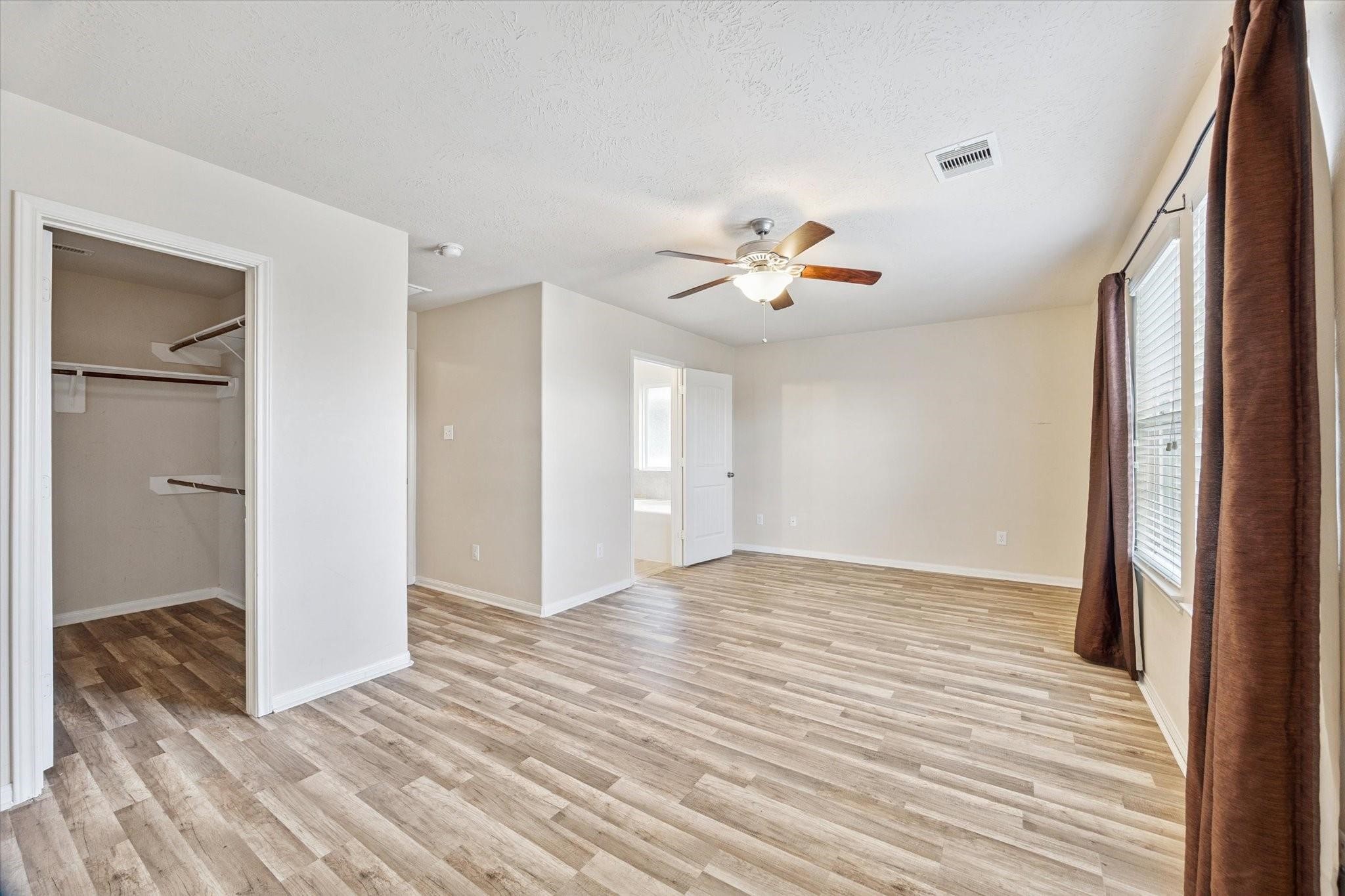 11718 Red Hummingbird Drive Houston, TX 77047 - Photo 6 of 13 a view of an empty room with wooden floor and a window