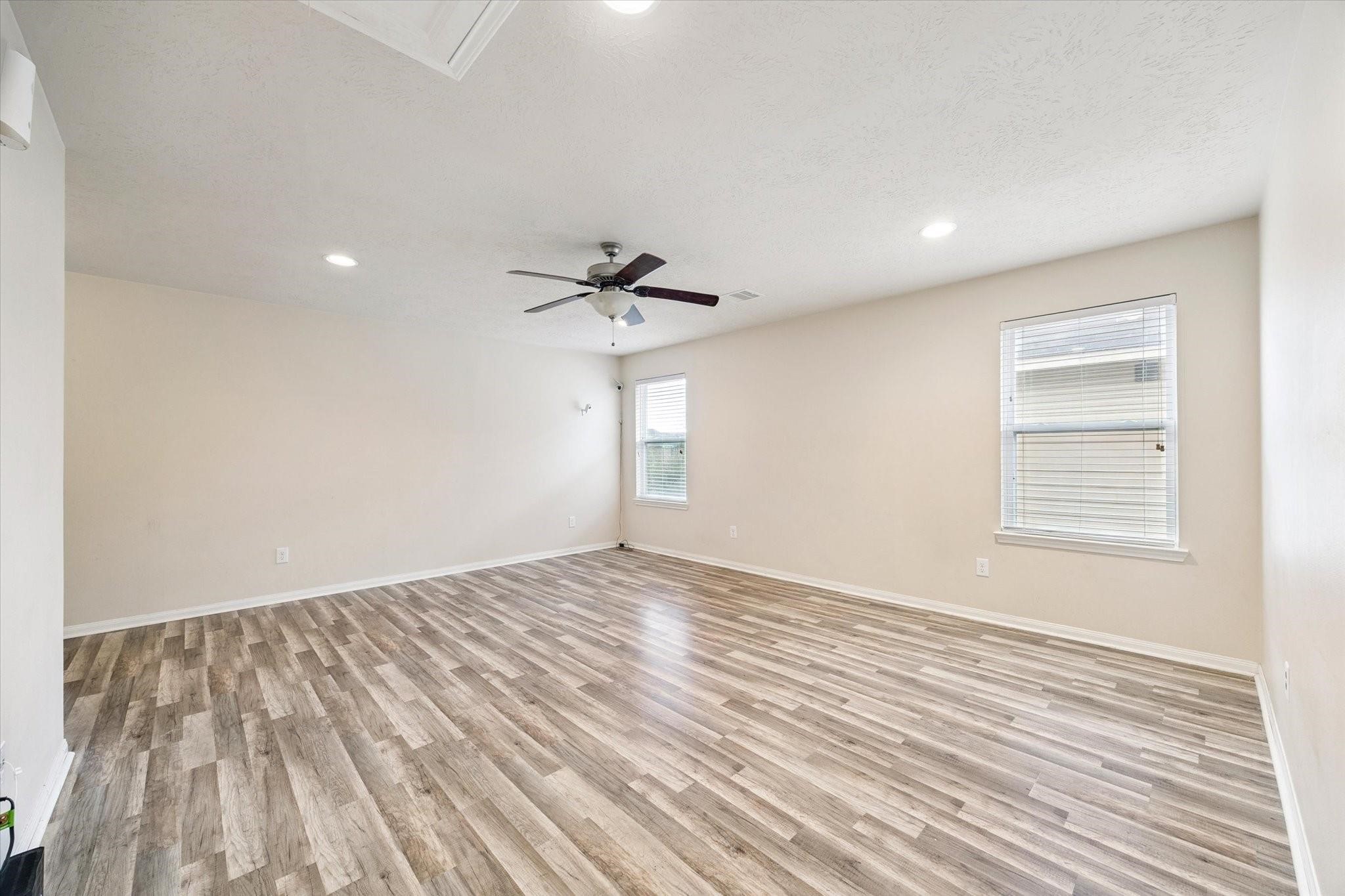 11718 Red Hummingbird Drive Houston, TX 77047 - Photo 8 of 13 a view of empty room with wooden floor and fan
