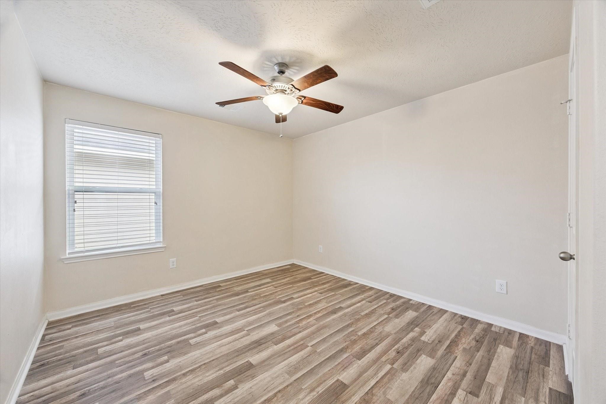 11718 Red Hummingbird Drive Houston, TX 77047 - Photo 9 of 13 an empty room with windows and fan