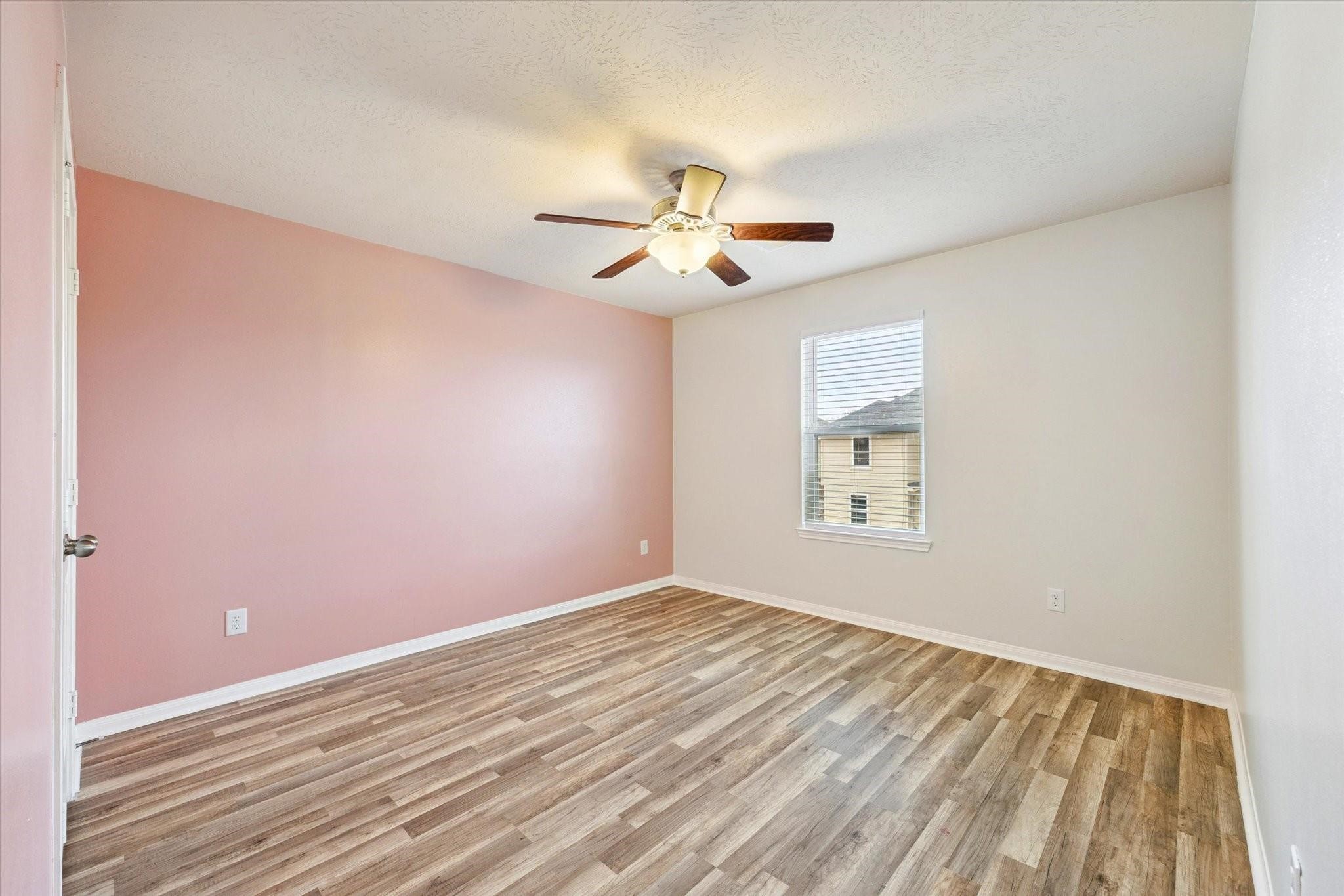 11718 Red Hummingbird Drive Houston, TX 77047 - Photo 10 of 13 wooden floor in an empty room with a window