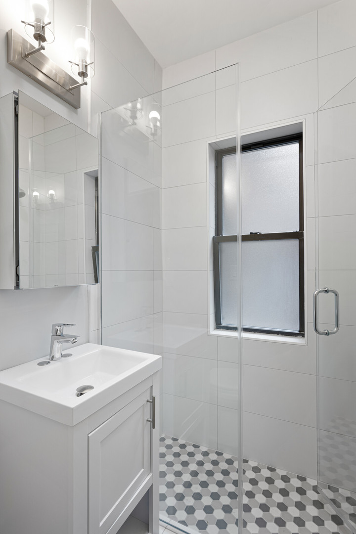 1651 West Jonquil Terrace, Unit 8 Chicago, IL 60626 - Photo 13 of 17 a bathroom with a sink and mirror