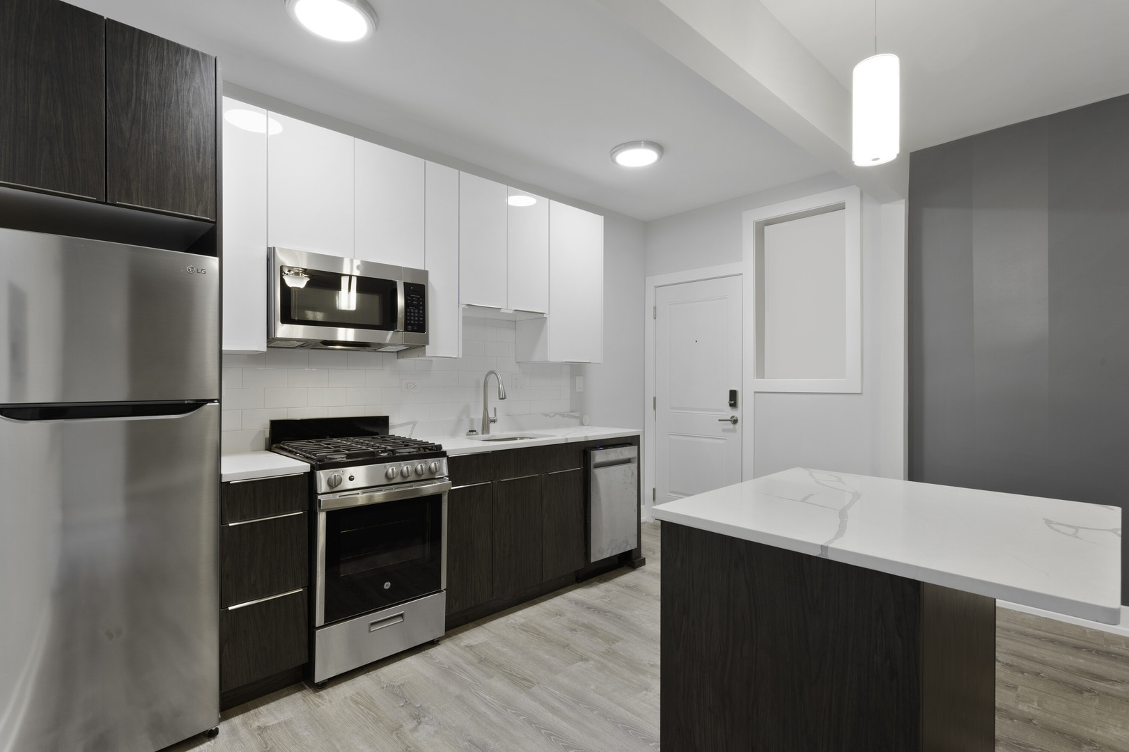 1651 West Jonquil Terrace, Unit 8 Chicago, IL 60626 - Photo 4 of 17 a kitchen with stainless steel appliances a stove microwave and refrigerator