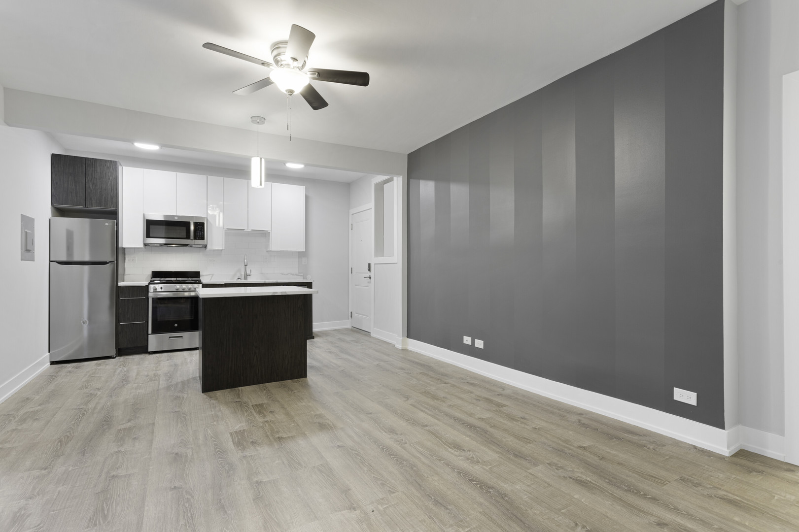 1651 West Jonquil Terrace, Unit 8 Chicago, IL 60626 - Photo 6 of 17 a view of kitchen with stainless steel appliances granite countertop a refrigerator a sink dishwasher and a stove with wooden floor