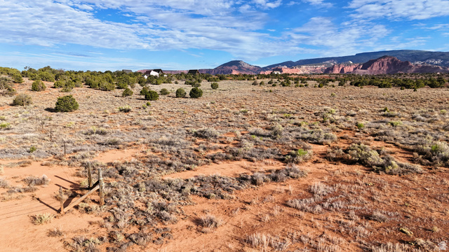 358 South Sky Drive Torrey, UT 84775 - Photo 68 of 82 Expansive desert landscape featuring natural brush, red-hued terrain, and scattered green foliage