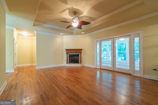 a open kitchen with stainless steel appliances granite countertop a refrigerator a stove top oven a sink dishwasher and wooden floor