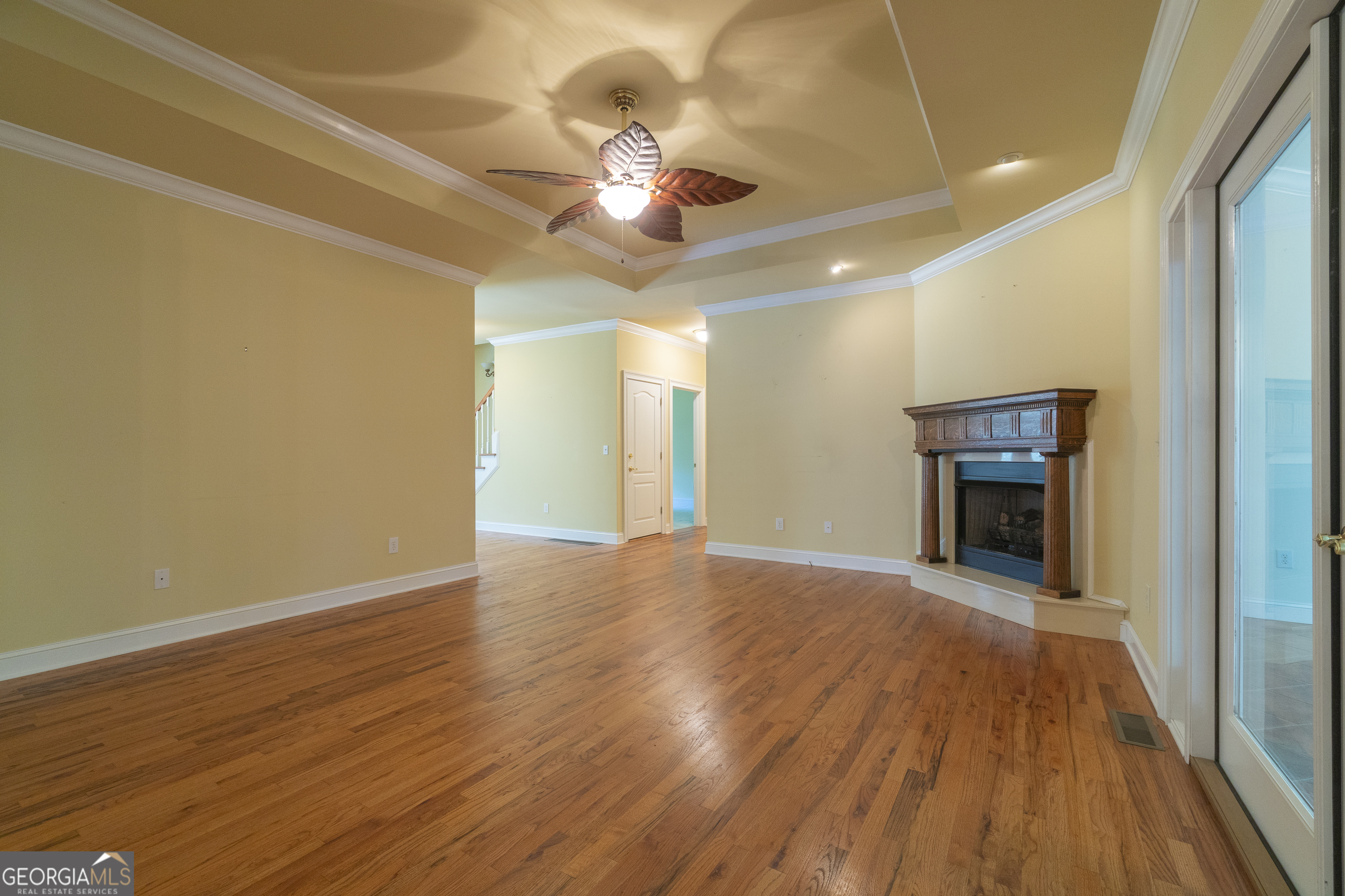 102 Trent Trail Cleveland, GA 30528 - Photo 20 of 108 a view of an empty room with wooden floor and a ceiling fan