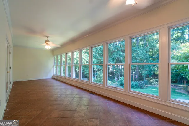 a view of a livingroom with a ceiling fan and window